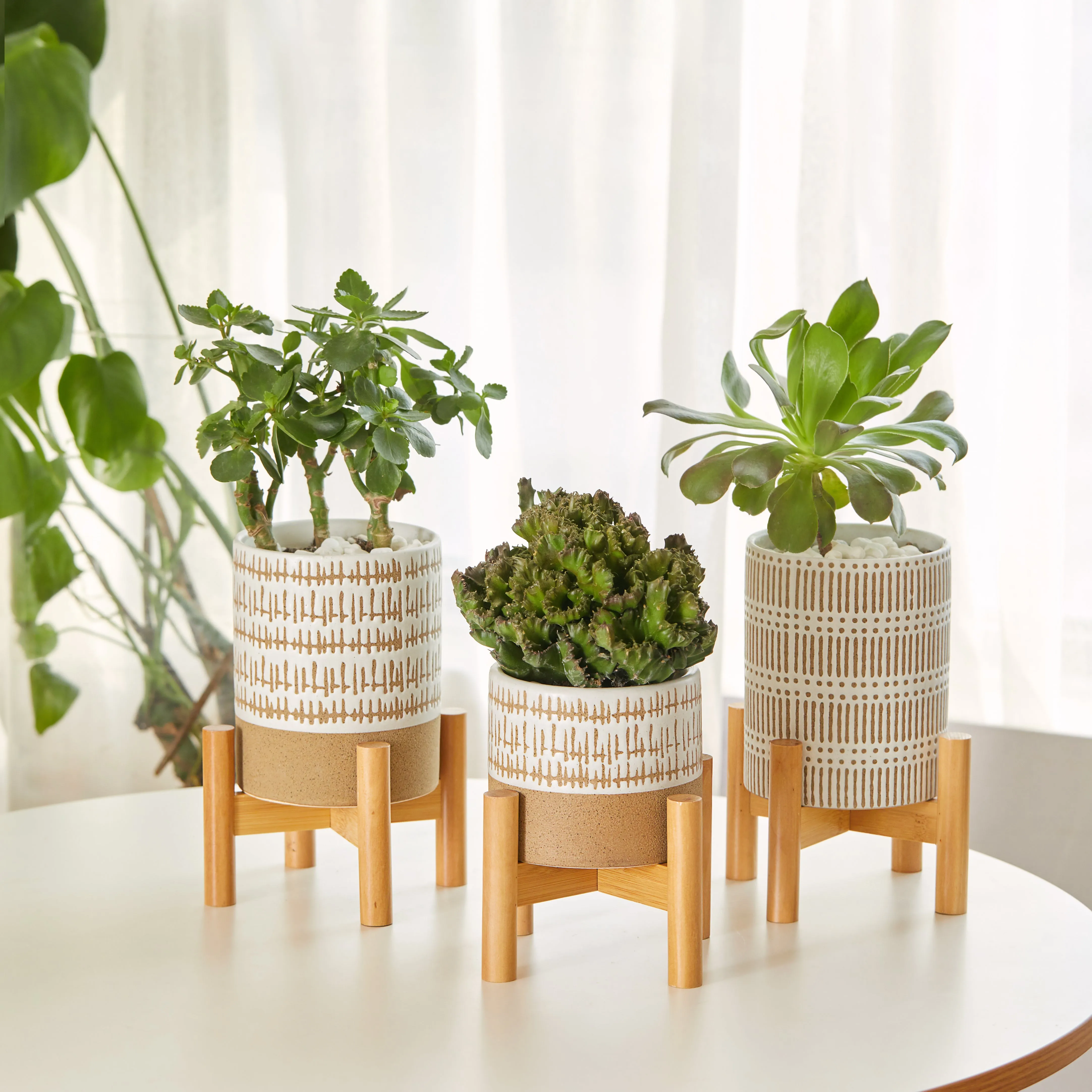 SET OF THREE SMALL STONEWARE POTS WITh STANDS - The large pots are 5.75" high.  The small pot is3.5" high. All three have a stand