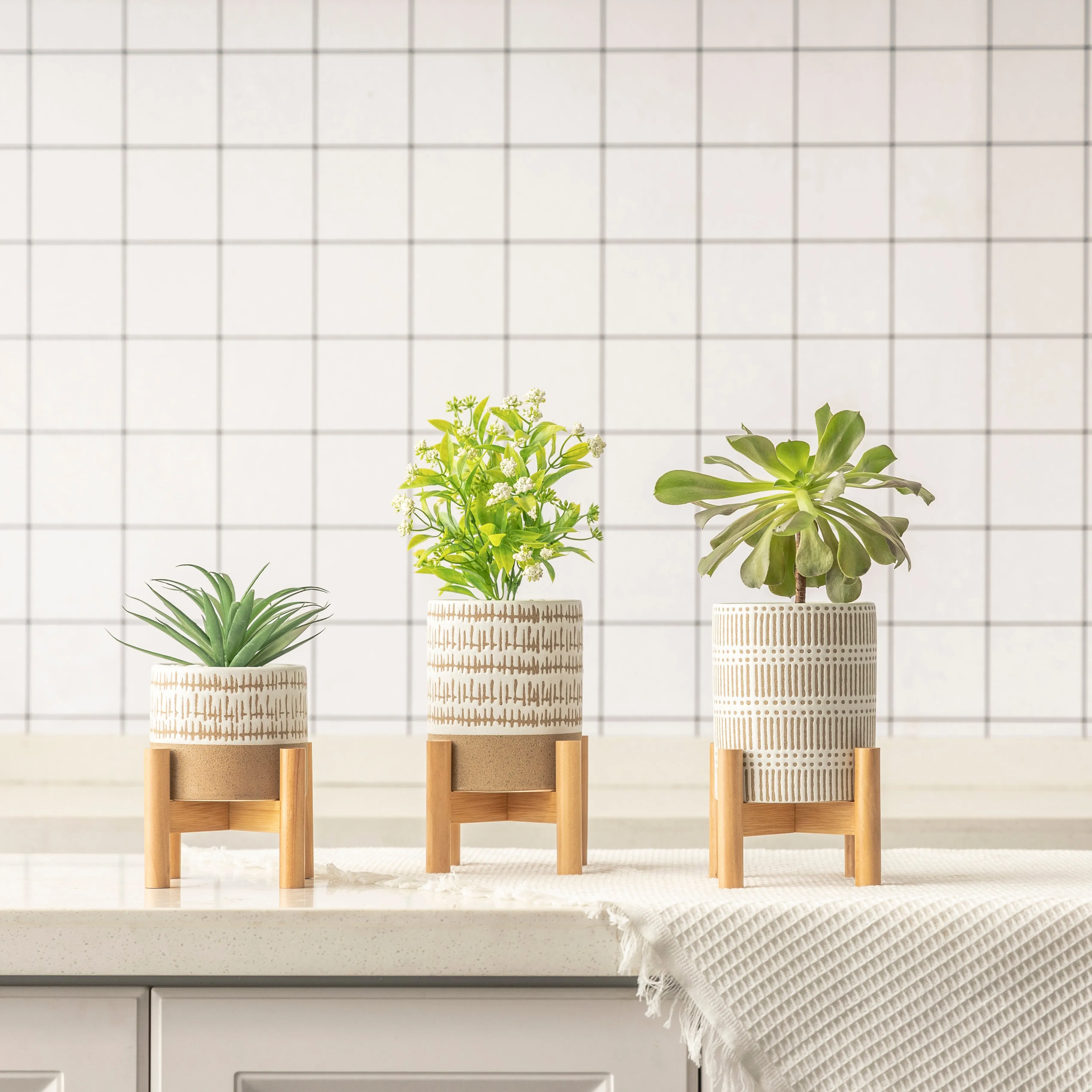 SET OF THREE SMALL STONEWARE POTS WITh STANDS - The large pots are 5.75" high.  The small pot is3.5" high. All three have a stand