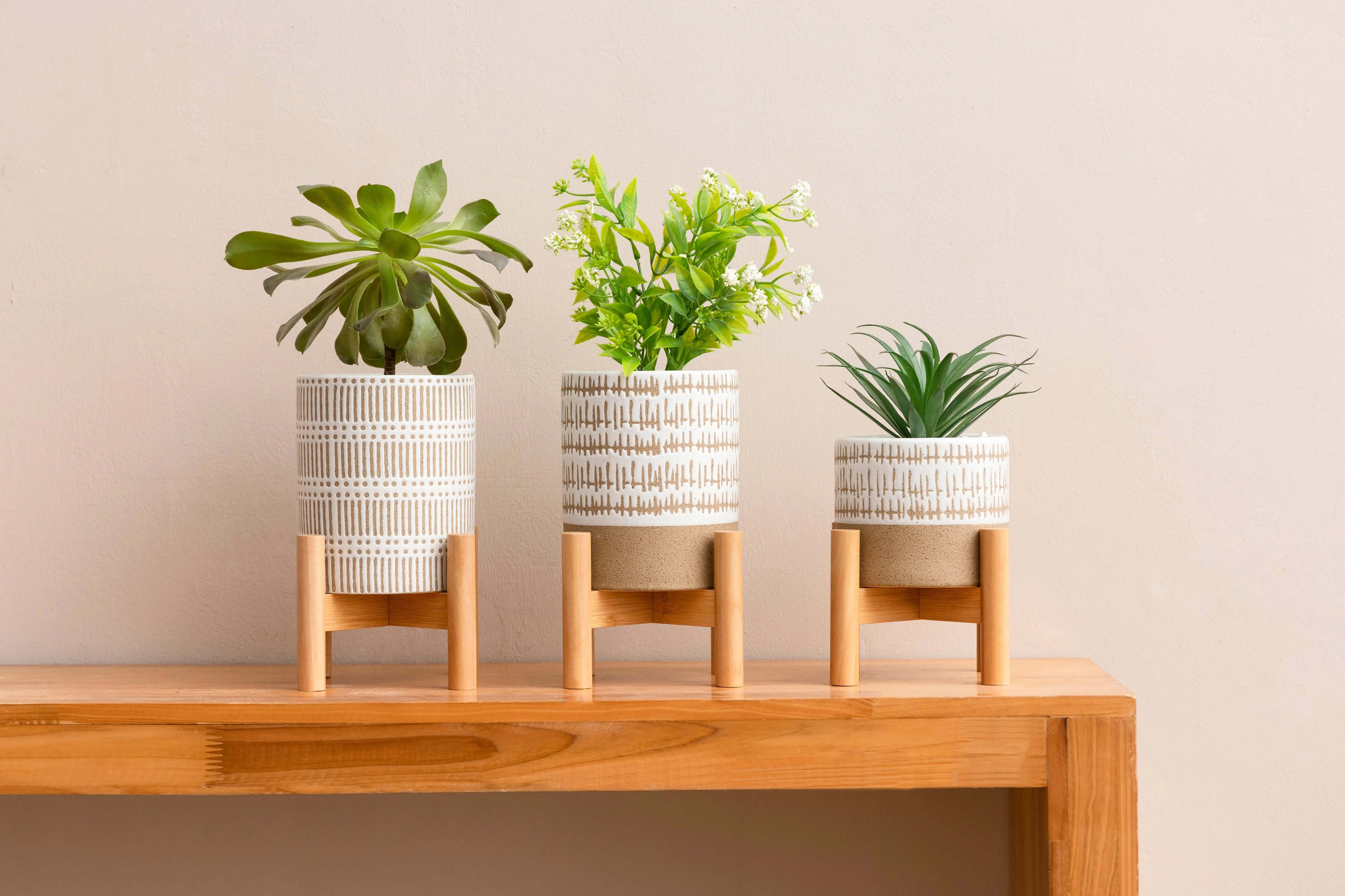 SET OF THREE SMALL STONEWARE POTS WITh STANDS - The large pots are 5.75" high.  The small pot is3.5" high. All three have a stand