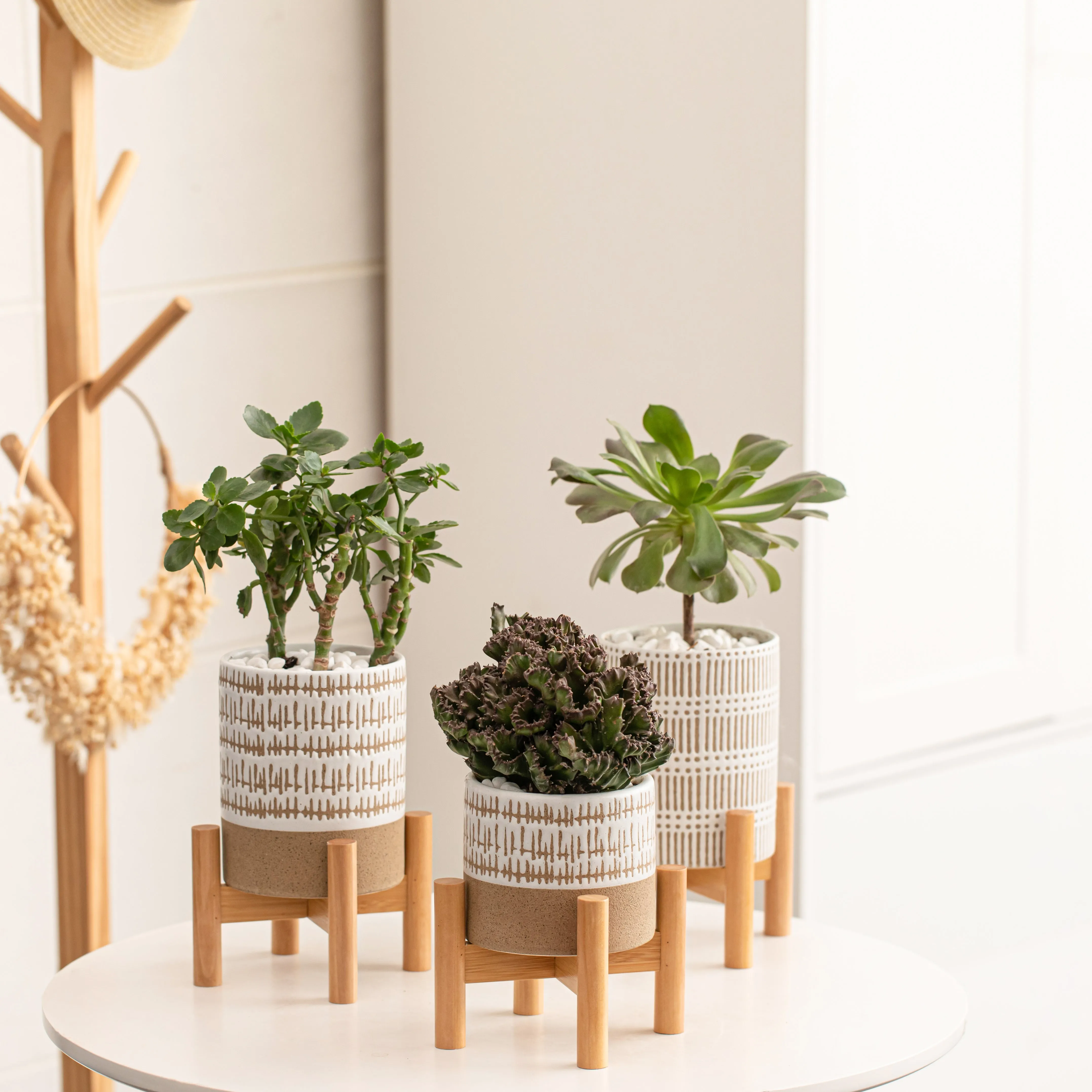 SET OF THREE SMALL STONEWARE POTS WITh STANDS - The large pots are 5.75" high.  The small pot is3.5" high. All three have a stand